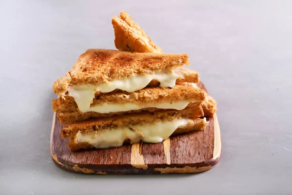 The perfect grilled cheese being cooked with ideal temperature and timing, showing a crispy, golden-brown crust and melted cheese inside.