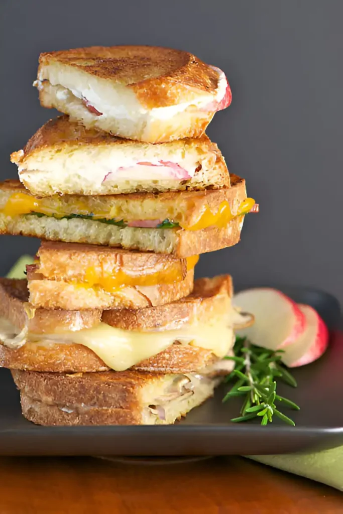 A variety of creative grilled cheese variations, showcasing different cheese blends, toppings, and unique ingredients like fruit, and sauces.

