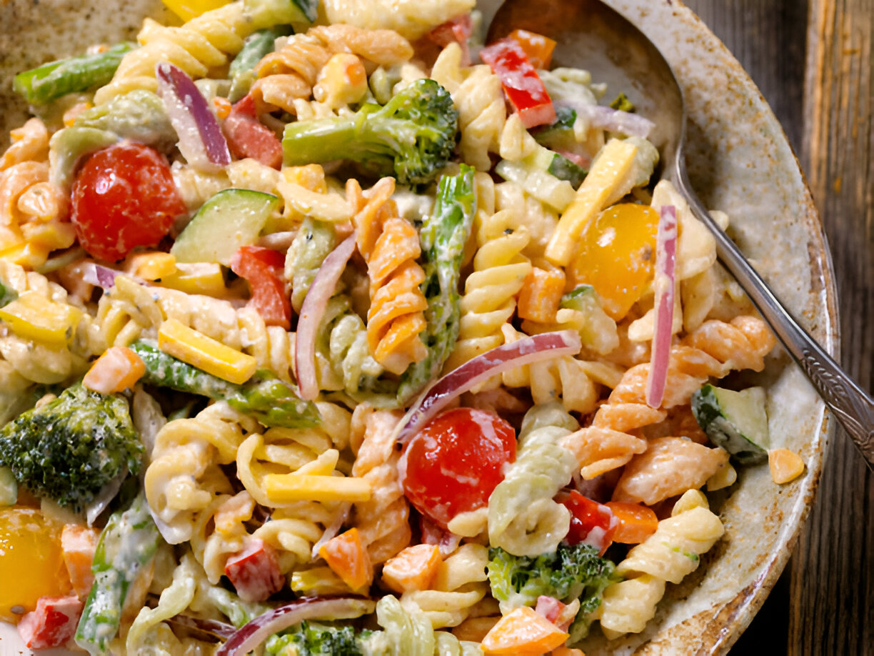 Colorful and vibrant pasta salad with fresh vegetables and a tangy dressing – a modern twist on a classic dish